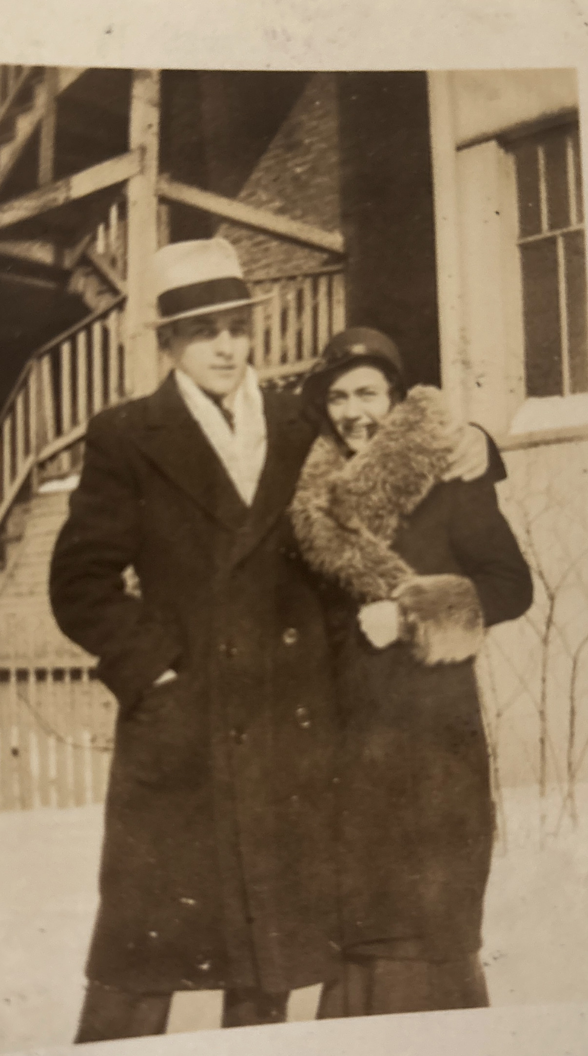 (Black and white) A couple in nice warm clothes standing together.